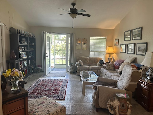 4027 Allure Ln, North Port, FL 34287 - living room featuring vaulted ceiling, a ceiling fan, and stone tile flooring