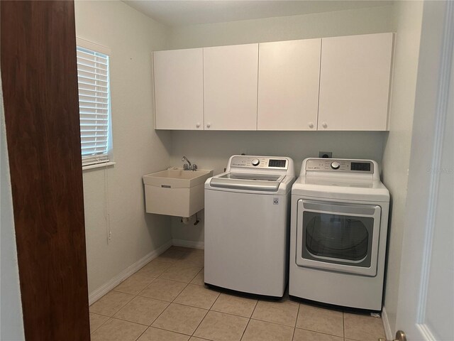 4027 Allure Ln, North Port, FL 34287 - laundry room featuring cabinet space, washing machine and clothes dryer, and light tile patterned flooring