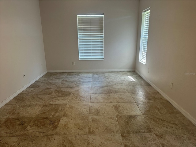 4027 Allure Ln, North Port, FL 34287 - spare room with baseboards and stone finish floors