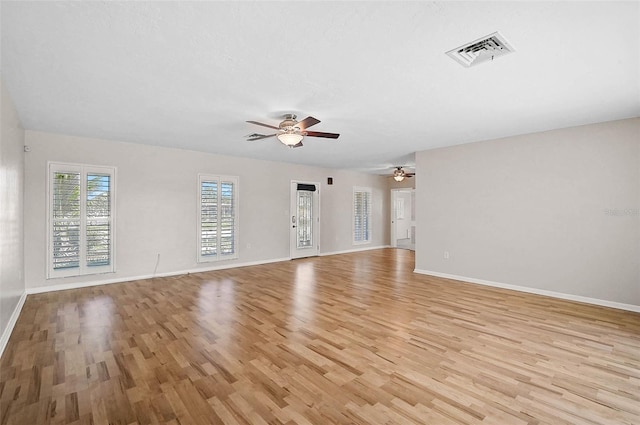 149 Small St SE, Port Charlotte, FL 33952 - unfurnished living room with light wood finished floors, ceiling fan, and baseboards