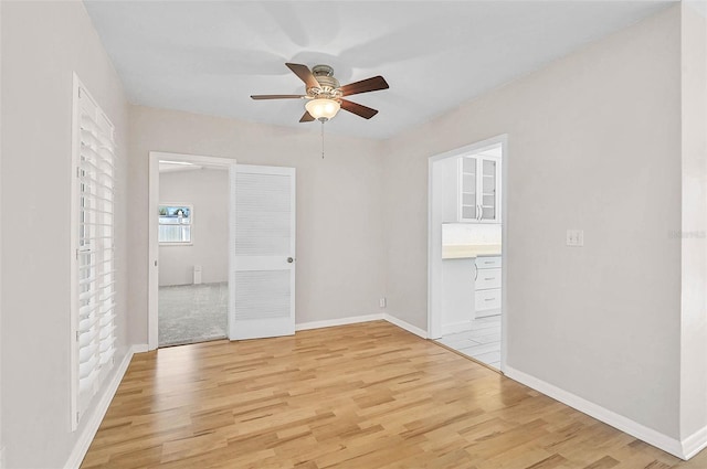 149 Small St SE, Port Charlotte, FL 33952 - spare room featuring ceiling fan, light wood-style flooring, and baseboards