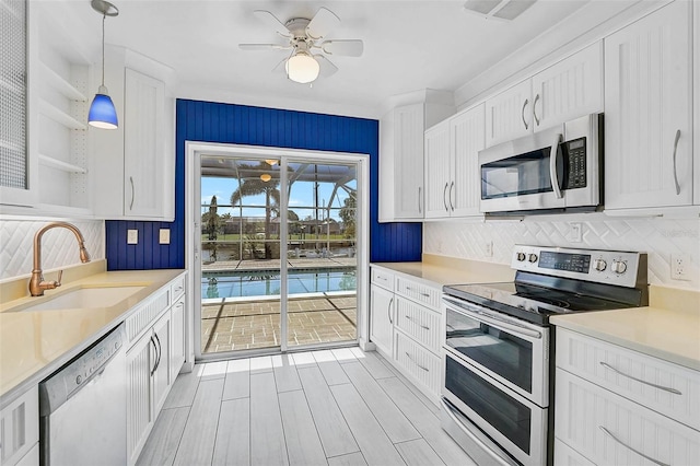 149 Small St SE, Port Charlotte, FL 33952 - kitchen featuring appliances with stainless steel finishes, a sink, white cabinets, and ceiling fan