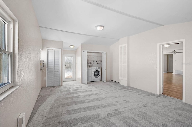 149 Small St SE, Port Charlotte, FL 33952 - unfurnished living room with a ceiling fan, a textured wall, carpet floors, and separate washer and dryer