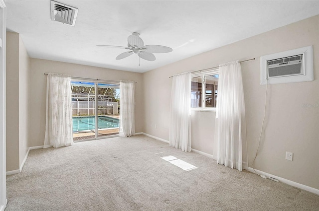 149 Small St SE, Port Charlotte, FL 33952 - carpeted empty room featuring a ceiling fan, baseboards, and a wall mounted air conditioner