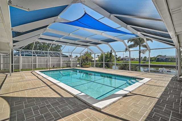 149 Small St SE, Port Charlotte, FL 33952 - view of pool with a patio, glass enclosure, and a water view