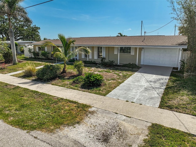 149 Small St SE, Port Charlotte, FL 33952 - ranch-style home with an attached garage, concrete driveway, stucco siding, and a front lawn