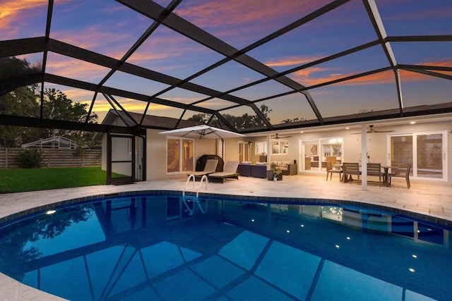 5581 Shadow Lawn Dr, Sarasota, FL 34242 - pool at dusk featuring an outdoor pool, ceiling fan, an outdoor living space, and a patio area