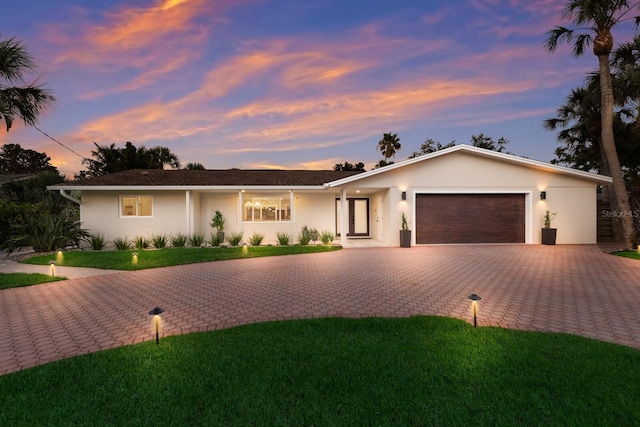 5581 Shadow Lawn Dr, Sarasota, FL 34242 - single story home featuring an attached garage, stucco siding, driveway, and a lawn