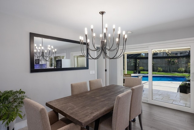 5581 Shadow Lawn Dr, Sarasota, FL 34242 - dining room with a chandelier and wood finished floors