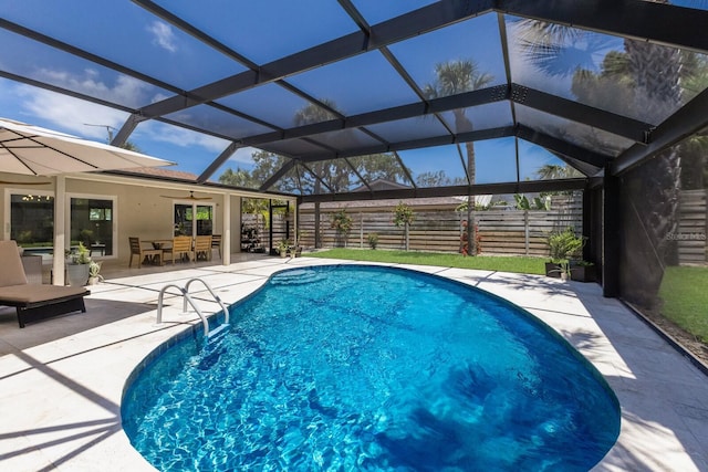 5581 Shadow Lawn Dr, Sarasota, FL 34242 - view of pool with a ceiling fan, a patio area, a fenced backyard, and glass enclosure