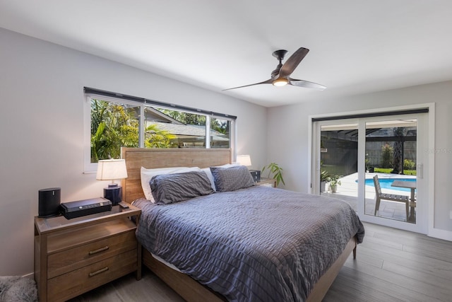 5581 Shadow Lawn Dr, Sarasota, FL 34242 - bedroom featuring access to exterior, wood finished floors, and a ceiling fan