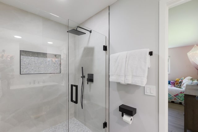 5581 Shadow Lawn Dr, Sarasota, FL 34242 - ensuite bathroom featuring a shower stall, recessed lighting, and wood finished floors
