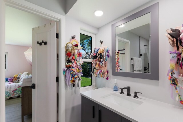 5581 Shadow Lawn Dr, Sarasota, FL 34242 - bathroom with vanity, wood finished floors, and connected bathroom