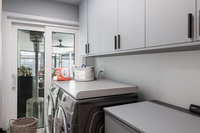 5581 Shadow Lawn Dr, Sarasota, FL 34242 - laundry room with cabinet space and washing machine and dryer