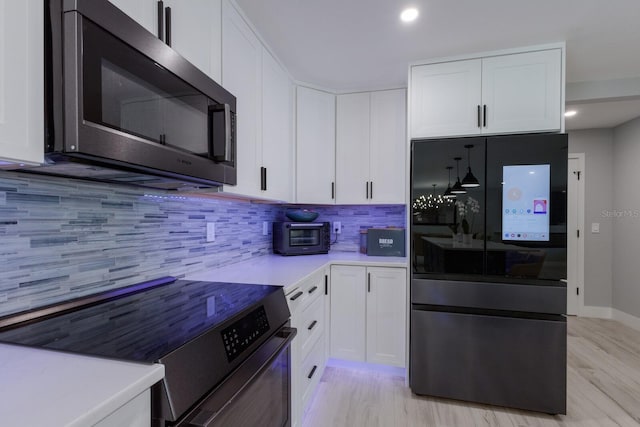 5581 Shadow Lawn Dr, Sarasota, FL 34242 - kitchen featuring appliances with stainless steel finishes, light wood-style flooring, white cabinetry, and recessed lighting