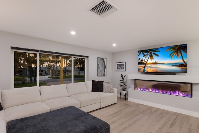 5581 Shadow Lawn Dr, Sarasota, FL 34242 - living room with wood finished floors, recessed lighting, baseboards, and a glass covered fireplace