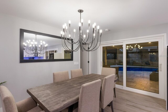 5581 Shadow Lawn Dr, Sarasota, FL 34242 - dining area with a chandelier and wood finished floors