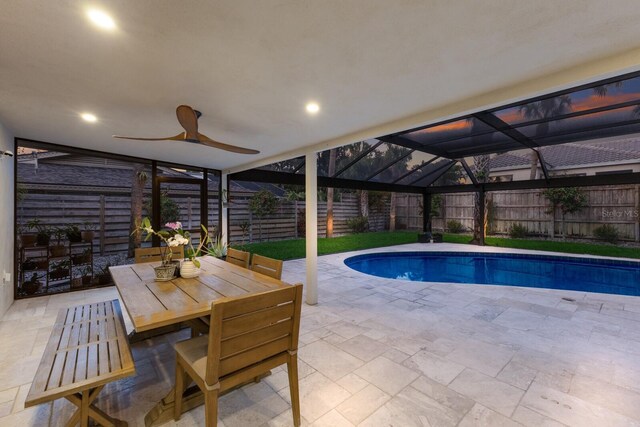 5581 Shadow Lawn Dr, Sarasota, FL 34242 - view of swimming pool featuring a patio, a fenced backyard, a ceiling fan, a lanai, and outdoor dining space