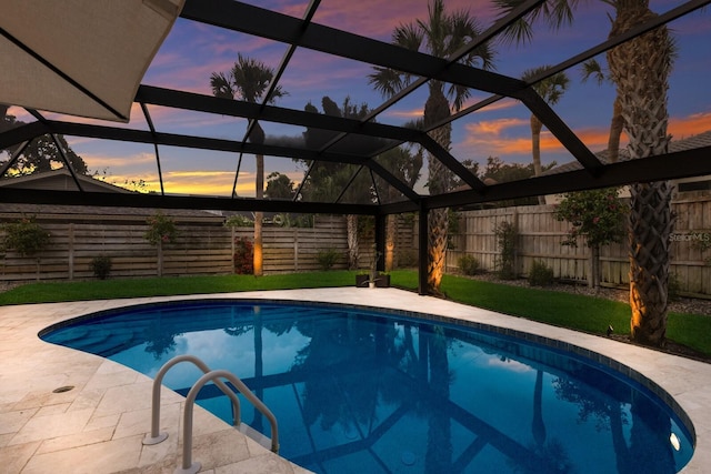 5581 Shadow Lawn Dr, Sarasota, FL 34242 - pool at dusk with a fenced backyard, a lanai, and a patio