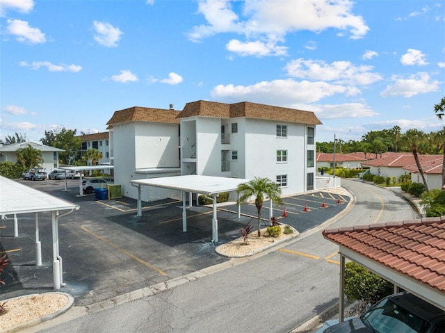 110 Vista Hermosa Cir Unit 302B, Sarasota, FL 34242 - view of property with covered and uncovered parking and a residential view