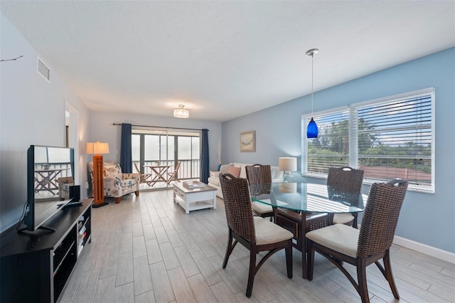 110 Vista Hermosa Cir Unit 302B, Sarasota, FL 34242 - dining area featuring plenty of natural light, light wood-type flooring, and baseboards