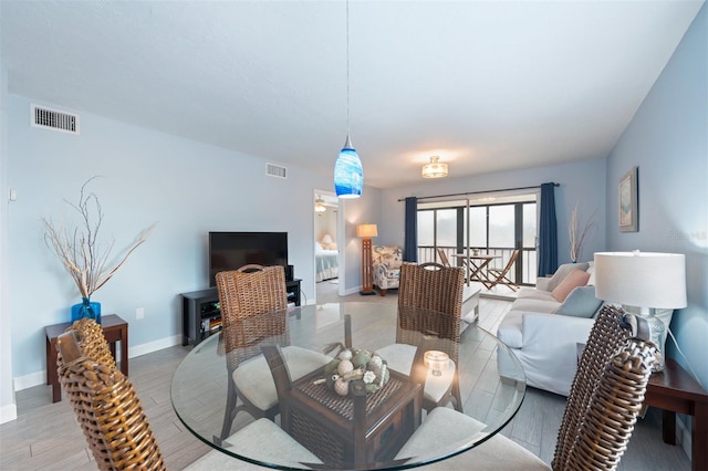 110 Vista Hermosa Cir Unit 302B, Sarasota, FL 34242 - dining area with baseboards and light wood-style floors