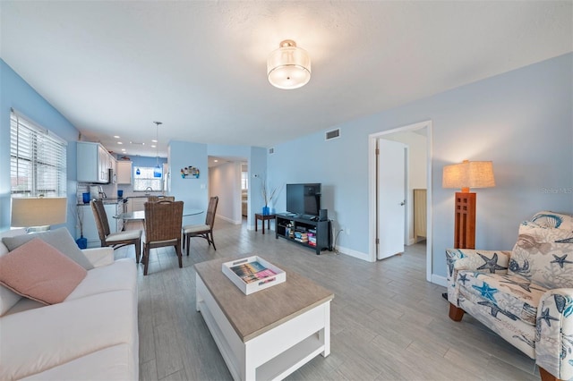 110 Vista Hermosa Cir Unit 302B, Sarasota, FL 34242 - living area featuring light wood finished floors and baseboards