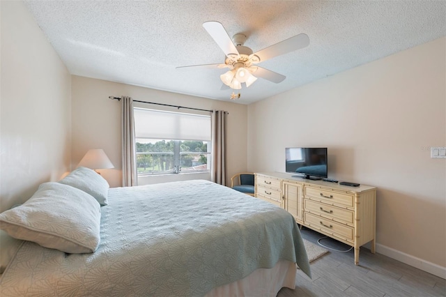 110 Vista Hermosa Cir Unit 302B, Sarasota, FL 34242 - bedroom featuring wood finished floors, baseboards, a textured ceiling, and ceiling fan