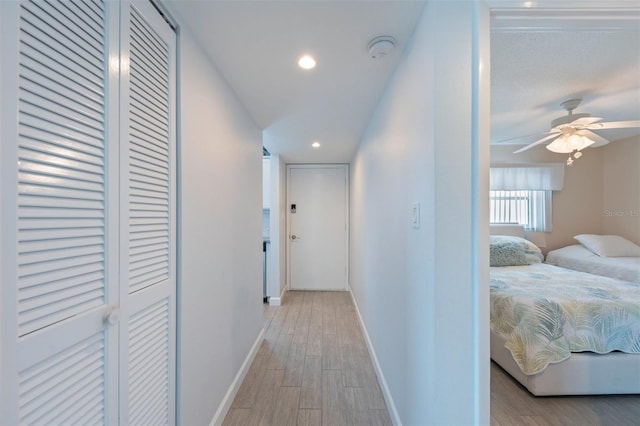 110 Vista Hermosa Cir Unit 302B, Sarasota, FL 34242 - hallway featuring light wood finished floors, baseboards, and recessed lighting