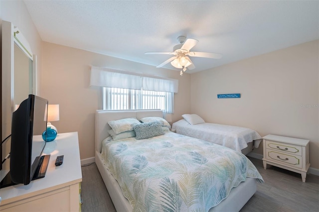 110 Vista Hermosa Cir Unit 302B, Sarasota, FL 34242 - bedroom with baseboards, wood finished floors, and a ceiling fan
