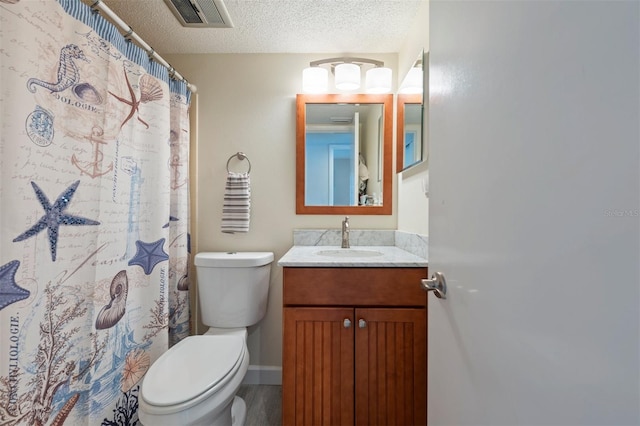 110 Vista Hermosa Cir Unit 302B, Sarasota, FL 34242 - full bath featuring toilet, vanity, a textured ceiling, a shower with shower curtain, and baseboards