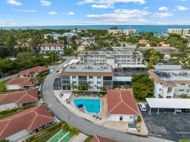 110 Vista Hermosa Cir Unit 302B, Sarasota, FL 34242 - drone / aerial view of a pool and a nearby body of water