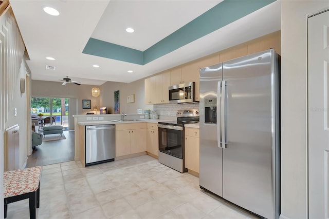 1216 Rio De Janeiro Ave Unit 306, Punta Gorda, FL 33983 - kitchen with stainless steel appliances, a peninsula, a sink, light countertops, and a ceiling fan