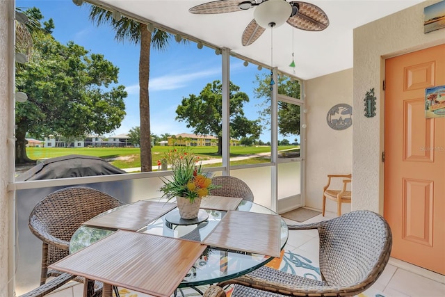 1216 Rio De Janeiro Ave Unit 306, Punta Gorda, FL 33983 - sunroom / solarium featuring a ceiling fan, outdoor dining space, and golf course view