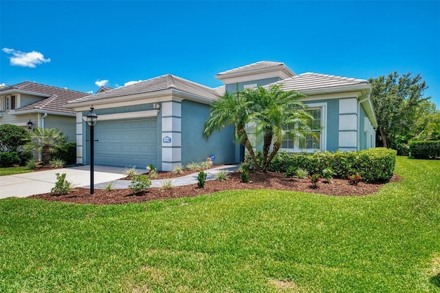 12229 Stuart Dr, Venice, FL 34293 - view of front of home with a tiled roof, driveway, an attached garage, a front yard, and stucco siding