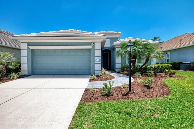 12229 Stuart Dr, Venice, FL 34293 - view of front facade featuring concrete driveway, a garage, cooling unit, a tile roof, and stucco siding