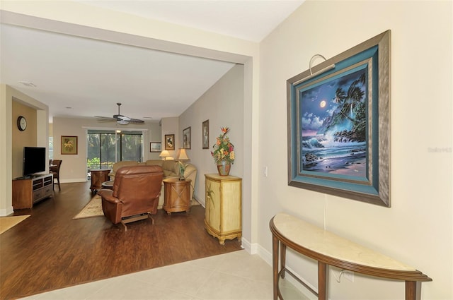 12229 Stuart Dr, Venice, FL 34293 - living area featuring a ceiling fan, wood finished floors, and baseboards