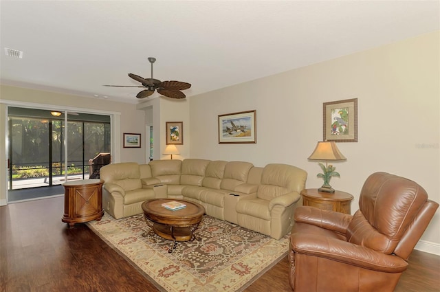 12229 Stuart Dr, Venice, FL 34293 - living room featuring dark wood-style flooring, a ceiling fan, and baseboards
