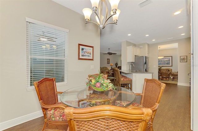 12229 Stuart Dr, Venice, FL 34293 - dining area featuring a chandelier, wood finished floors, baseboards, and recessed lighting