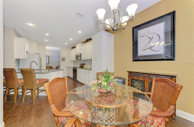 12229 Stuart Dr, Venice, FL 34293 - dining space with dark wood-style floors, a chandelier, recessed lighting, and baseboards