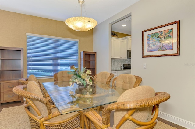 12229 Stuart Dr, Venice, FL 34293 - dining area with wood finished floors, baseboards, and recessed lighting