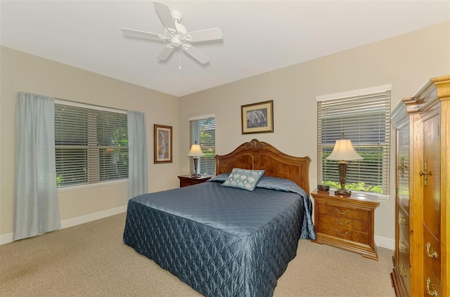 12229 Stuart Dr, Venice, FL 34293 - bedroom with light carpet, baseboards, and ceiling fan