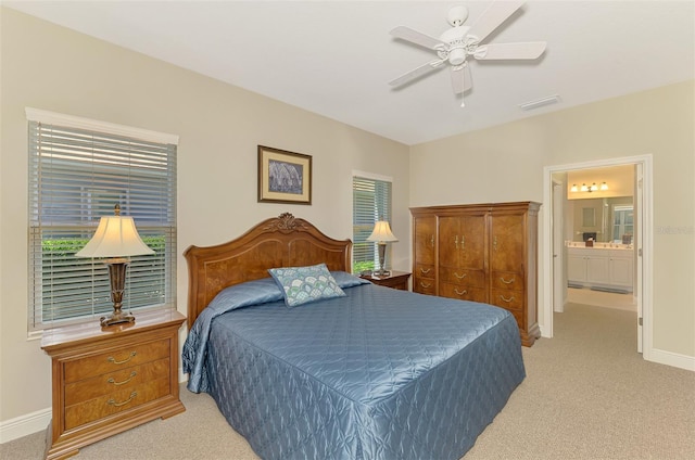 12229 Stuart Dr, Venice, FL 34293 - bedroom with light carpet, baseboards, and ensuite bathroom