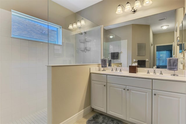 12229 Stuart Dr, Venice, FL 34293 - full bath featuring a walk in shower, double vanity, and tile patterned flooring
