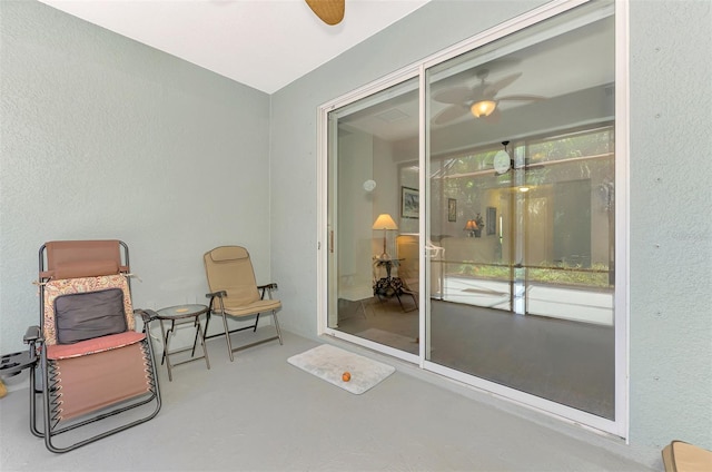 12229 Stuart Dr, Venice, FL 34293 - sitting room with ceiling fan and concrete floors