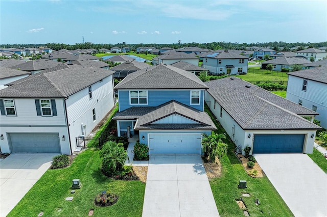 8940 Royal River Cir, Parrish, FL 34219 - traditional home featuring a residential view, driveway, a front lawn, and roof with shingles