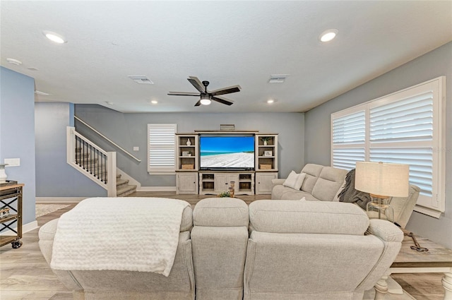 8940 Royal River Cir, Parrish, FL 34219 - living room with a ceiling fan, stairs, recessed lighting, baseboards, and light wood-type flooring