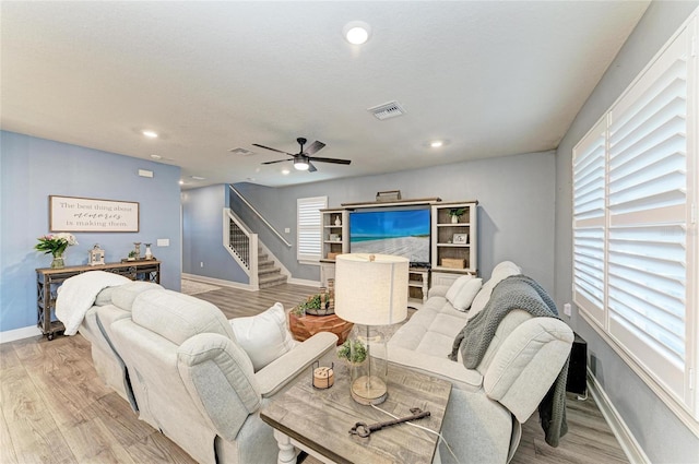 8940 Royal River Cir, Parrish, FL 34219 - living room with stairway, light wood-style floors, a ceiling fan, baseboards, and recessed lighting