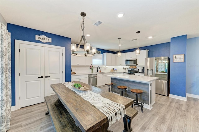 8940 Royal River Cir, Parrish, FL 34219 - dining area featuring a chandelier, light wood-type flooring, baseboards, and recessed lighting