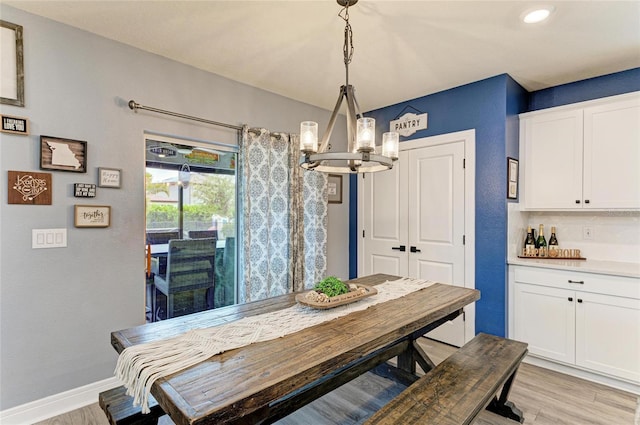 8940 Royal River Cir, Parrish, FL 34219 - dining area featuring a chandelier, light wood-style floors, and baseboards